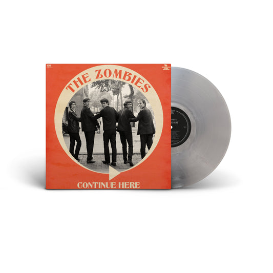 Vinyl record album with a bright orange cover featuring a circular black-and-white band photo and the text 'THE ZOMBIES' and 'CONTINUE HERE,' shown  gray record partially pulled from the sleeve.