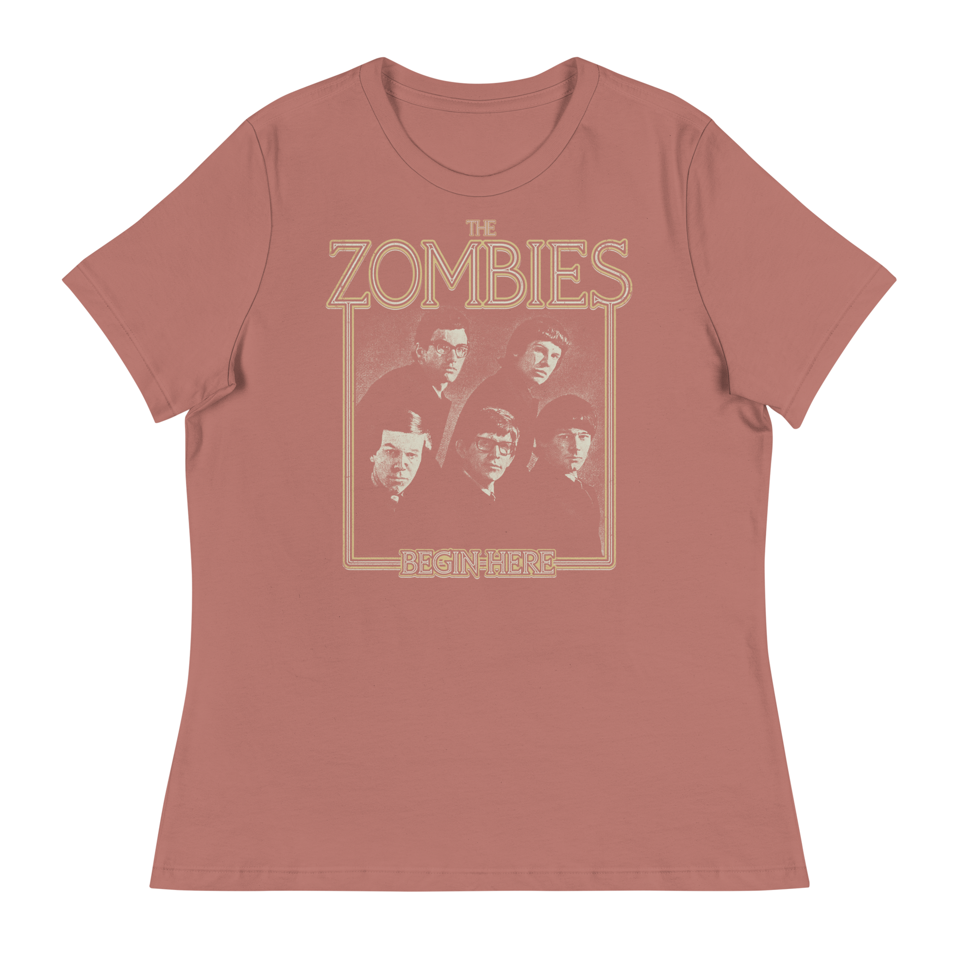 A dusty rose short-sleeve t-shirt with a vintage-style graphic of the band The Zombies and the text 'THE ZOMBIES' and 'BEGIN HERE' in a tan outline print.